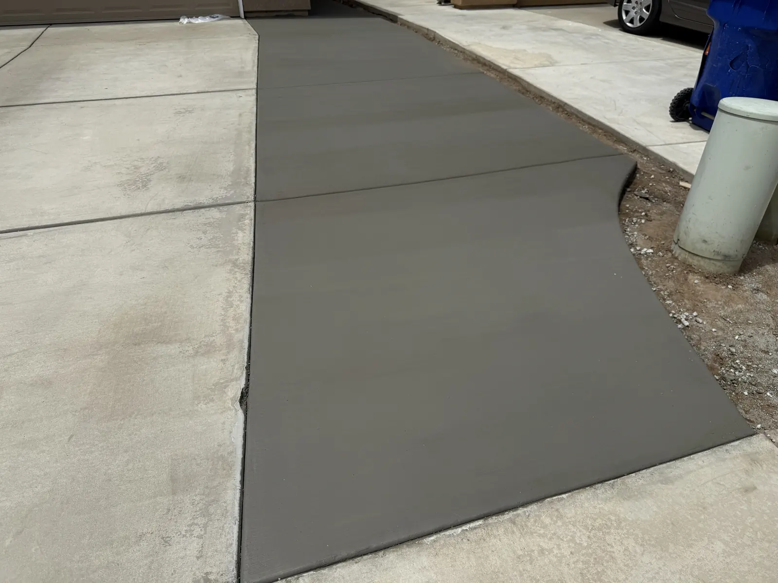 Widened driveway reaching the curb, finished level with the original slab