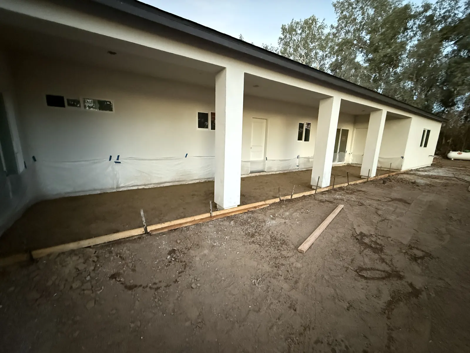 Formed and staked ground along a new column porch, ready for the pour