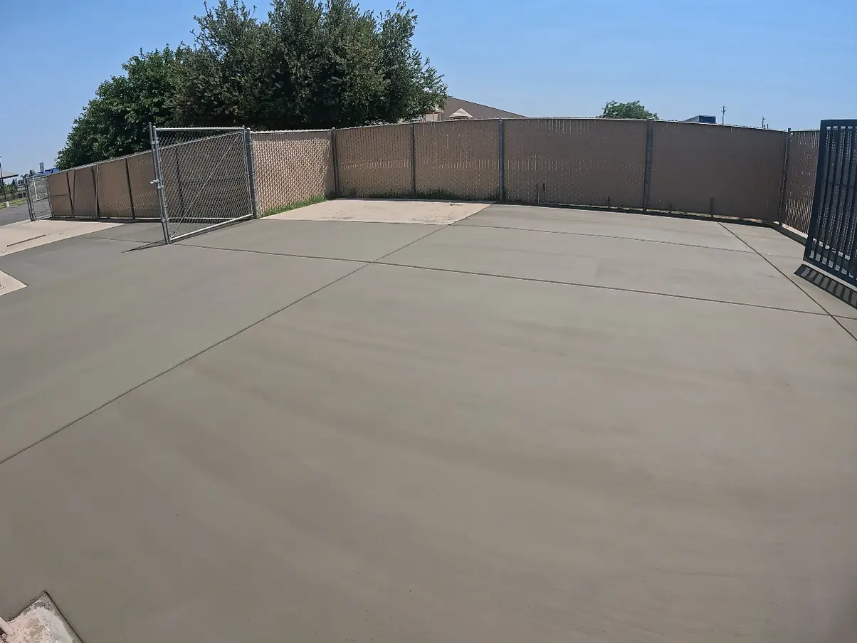 Finished pad filling the fenced yard and meeting the existing walkway at the gate
