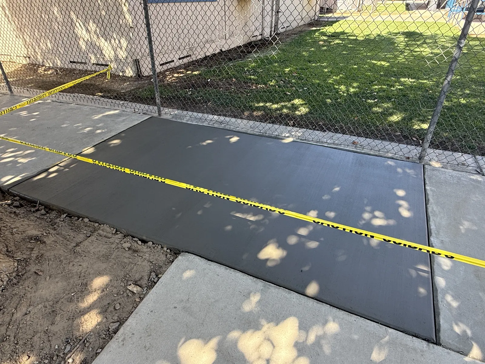 New slab filling the gap between the older sections, caution tape strung across it