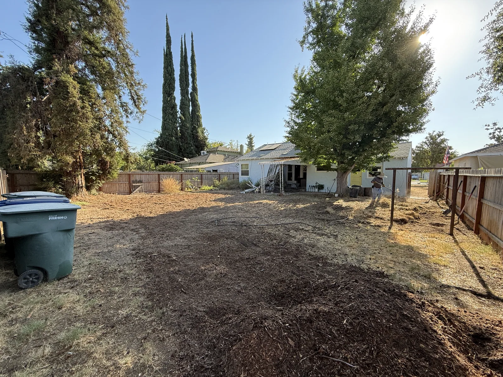 Wood forms and wire mesh staked out over graded soil where a curved entry walkway will be poured